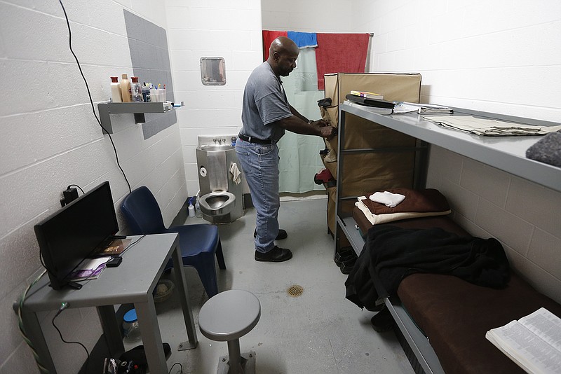 A resident straightens up his living area on May 5 at the Texas Civil Commitment Center, Bill Clayton Facility, in Littlefield, Texas. Many of Texas' most violent sex offenders have been housed for months in the former prison in rural West Texas, a place that the head of the state agency who oversees the overhauled program believes will lead to successful rehabilitations. 