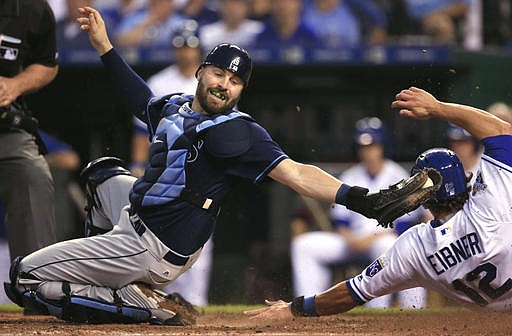 Tampa Bay Rays catcher Curt Casali, left, misses the tag on Kansas City Royals' Brett Eibner (12) during the fourth inning of a baseball game at Kauffman Stadium in Kansas City, Mo., Tuesday, May 31, 2016. Eibner scored on a bunt by Drew Butera.
