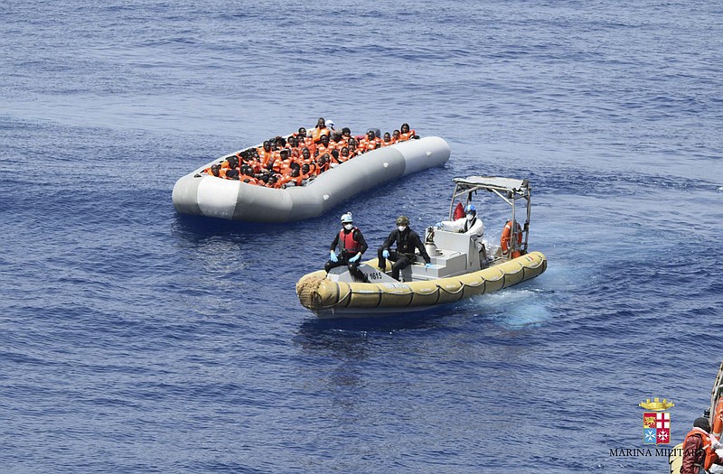 This undated image made available Monday, May 30, 2016 by the Italian Navy Marina Militare shows migrants being rescued at sea. Survivor accounts have pushed to more than 700 the number of migrants feared dead in Mediterranean Sea shipwrecks over three days in the past week, even as rescue ships saved thousands of others in daring operations.