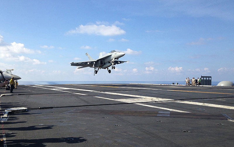 An FA-18 jet fighter lands on the USS John C. Stennis aircraft carrier in April in the South China Sea while U.S. Defense Secretary Ash Carter visited the aircraft carrier during a trip to the region. American ships and fighter jets maneuvering across the South China Sea and the Sea of Japan represent the "new normal" in U.S.-Pacific relations despite rising tensions with China and Russia. 