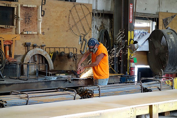 Grant Caley, cutting a piece of rebar, said he's worked for Mid America Precast for 25 years.