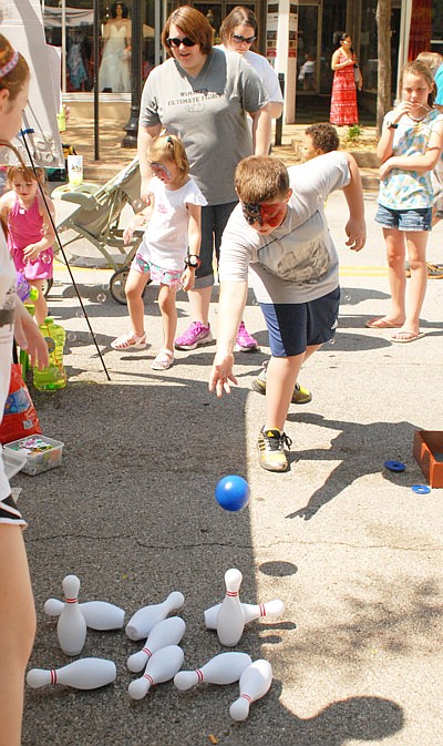 In this May 31, 2014 file photo, Connor Goodman of Holts Summit enjoys a game of bowling at the annual Kidsfest event held in downtown Jefferson City.