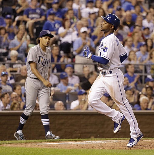 Kansas City Royals' Jarrod Dyson (1) crosses the plate past Tampa Bay Rays starting pitcher Chris Archer as he scores on sacrifice fly by Alcides Escobar during the sixth inning of a baseball game Wednesday, June 1, 2016, in Kansas City, Mo. 