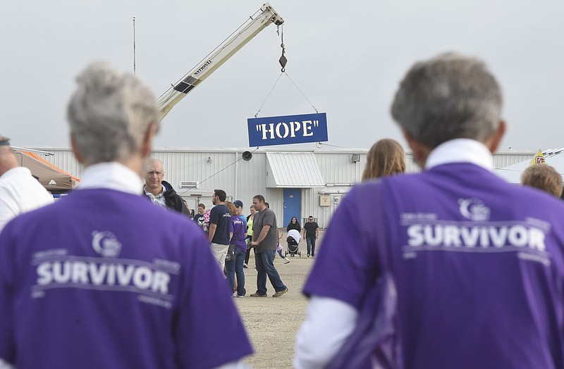 Cancer survivors Diane Brown, left, and her husband Delmer Brown walk hand in hand Friday at Relay for Life at the Jefferson City Jaycee Fairgrounds. The Browns have participated every year except the year their daughter Brandy Clark died from brain cancer.