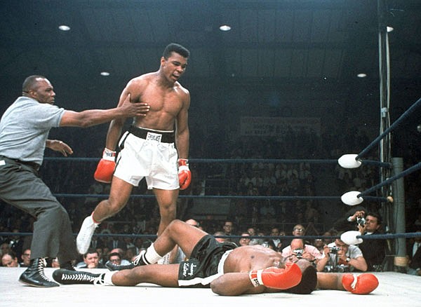 In this May 25, 1965, file photo, heavyweight champion Muhammad Ali is held back by referee Joe Walcott after knocking out Sonny Liston in the first round of their title fight in Lewiston, Maine.