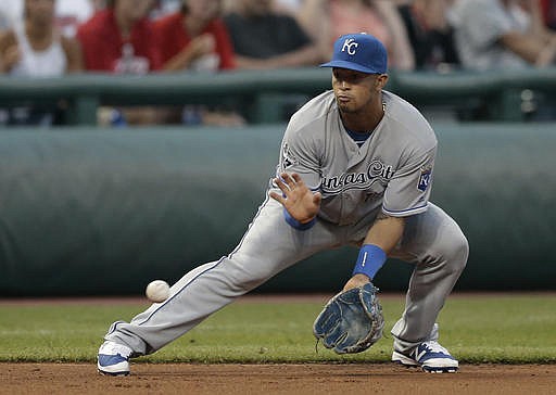 Kansas City Royals' Cheslor Cuthbert fields a ball hit by Cleveland Indians' Juan Uribe in the sixth inning of a baseball game, Friday, June 3, 2016, in Cleveland. Uribe was out on the play.
