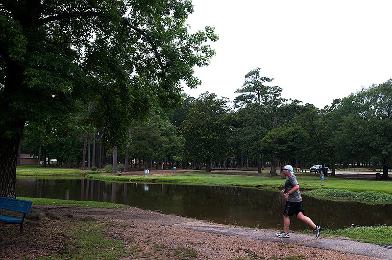 Dan Williams runs the trail Friday, June 3, 2016, at Spring Lake Park. The Texarkana, Texas, Parks and Recreation Department in May 2016 received a grant from the Texas Parks and Wildlife Department and soon will begin rebuilding the segment of the trail that surrounds the park's pond.