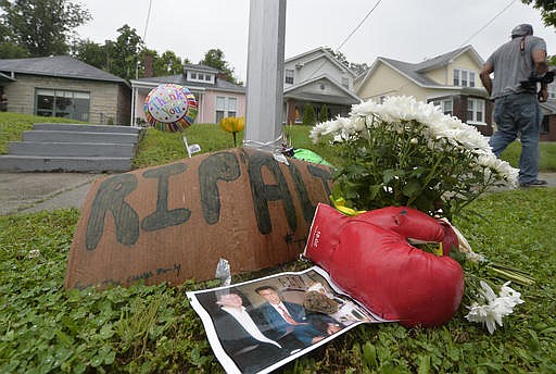 A small memorial sits in front of the boyhood home of Muhammad Ali, Saturday, June 4, 2016 in Louisville Ky. Ali, the magnificent heavyweight champion whose fast fists and irrepressible personality transcended sports and captivated the world, died Friday, June 3, 2016. He was 74. 