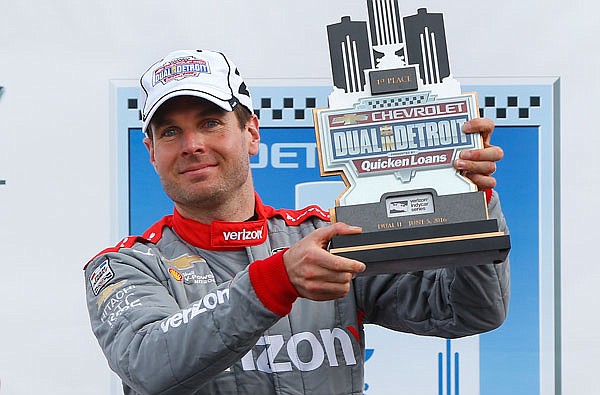 Will Power celebrates with the trophy Sunday after his win in the IndyCar Detroit Grand Prix in Detroit.