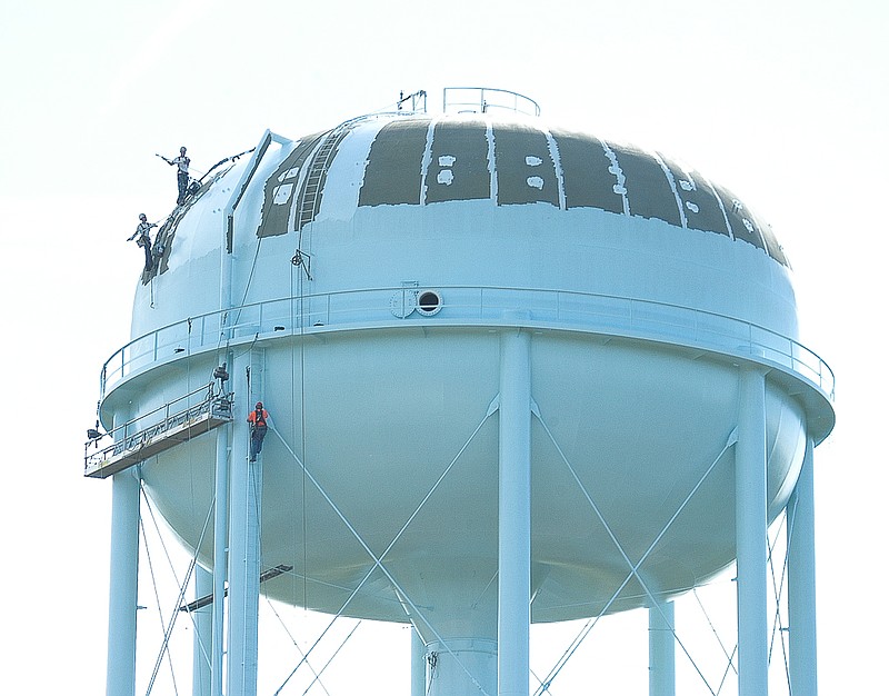 Workers can be seen engaged in renovation work of the million-gallon water tower on Russellville Road. The work is about 80 percent complete. The tower should be returned to service in August.