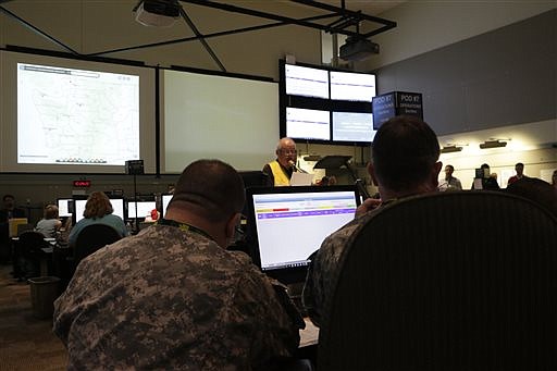 Members of the National Guard listen as State EOC supervisor Chris Utzinger reads messages about the latest details on a simulated tsunami during an earthquake and tsunami readiness drill, Tuesday, June 7, 2016, at Camp Murray, Wash. The four-day event, called Cascadia Rising, is built around the premise of a 9.0 magnitude earthquake 95 miles off of the coast of Oregon that results in a tsunami. 