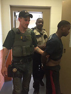 Allester Jermaine Stevens, 22, far right, was escorted back into the Lafayette County, Ark., jail Monday afternoon. Stevens escaped from the jail May 25 and remained a fugitive until officers received a tip Monday afternoon, telling them where he was hiding. Deputies Cameron Sundberg and Xavier Paschol directed the fugitive back into the jail.