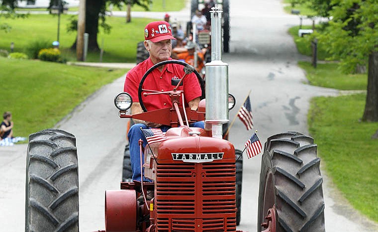 Richard Rackers, of New Bloomfield, drives his Farmall tractor in a past Russellville Engine Show and Frog Leg Festival. The annual event is held in the Russellville park and features food, crafts and demonstration tents.