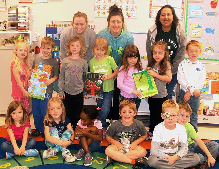 William Woods University students (left to right) Julia Carney, Kaila Stefka and Hope Gutierrez gather with some of the children from Fulton Preschool.