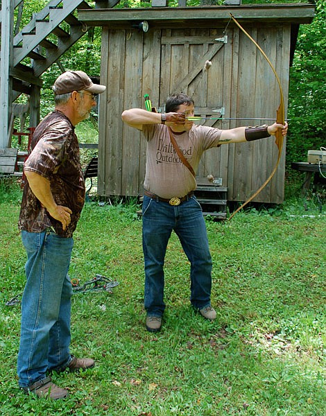 Bowhunting legend Bob Foulkrod, left, gives Brandon Butler tips on instinctive shooting.