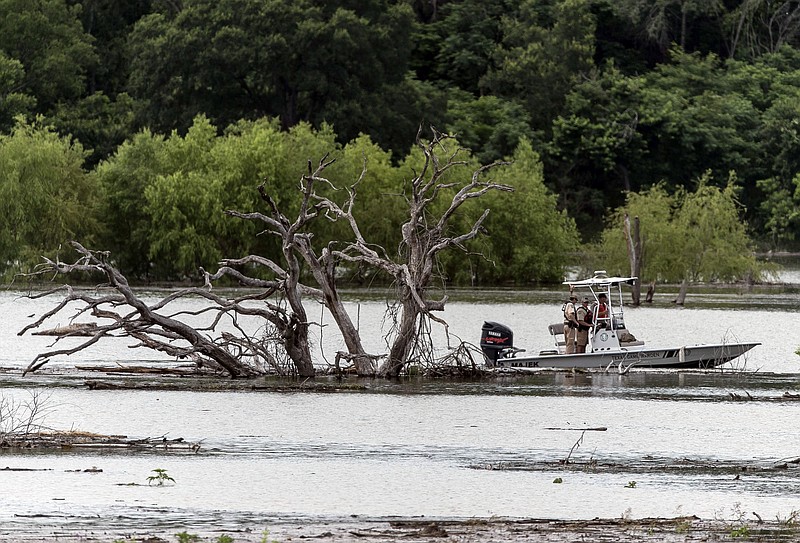 Texas Game Wardens boat search Belton Lake, Friday, June 3, 2016, where Owl Creek feeds into it for four missing soldiers from U.S Army's Fort Hood that were swept away in a low water crossing during training when the Army vehicle they were in was swept away on Thursday.  Five soldiers were killed, four are still missing and three were rescued on Thursday. 