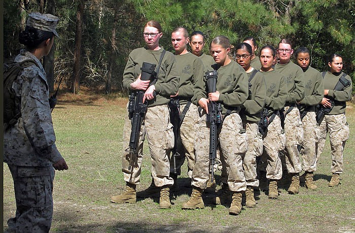 Female recruits wait for instructions at the Marine Corps Training Depot on Parris Island, South Carolina. U.S. Secretary of the Navy Ray Mabus said in an interview the Navy and Marine Corps will be dropping "man" from some of their job titles to make them inclusive and gender-neutral. 
