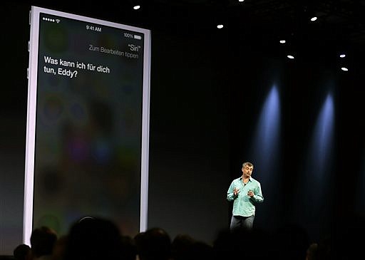 In this June 10, 2013, file photo, Eddy Cue, Apple senior vice president of internet software and services, talks about the Siri virtual assistant during the keynote address of the Apple Worldwide Developers Conference in San Francisco. 