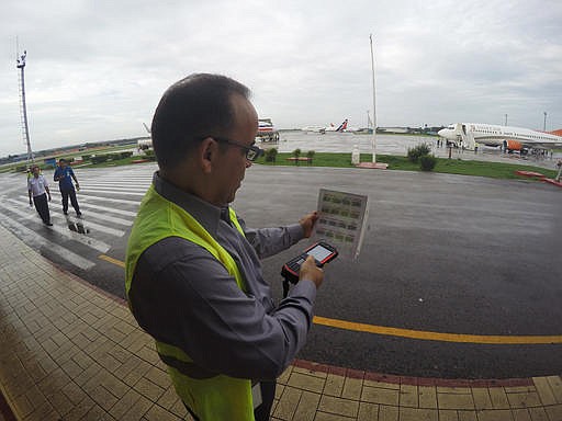 In this Thursday, June 9, 2016, photo, Galo Beltran, Cuba country manager for American Airlines, tests a handheld baggage scanner at Havana's Jose Marti International Airport.