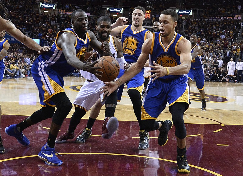 Golden State Warriors' Draymond Green, Cleveland Cavaliers' Kyrie Irving, and Warriors' Klay Thompson (11) and Stephen Curry. from left, pursue a loose ball during the second half of Game 4 of basketball's NBA Finals in Cleveland, Friday, June 10, 2016. Golden State won 108-97. 