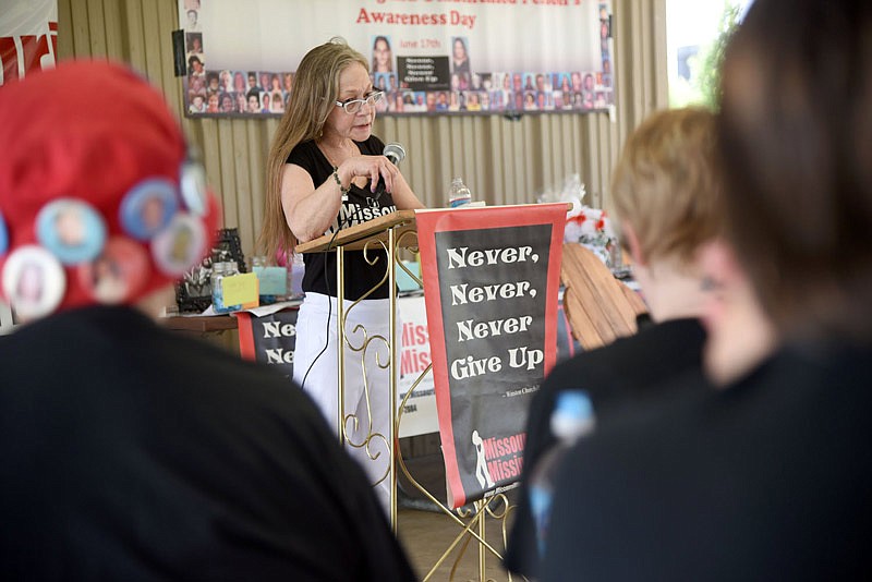 Marianne Asher-Chapman, co-founder of Missouri Missing, speaks at the Missouri Missing and Unidentified Persons Awareness Day event in Jefferson City on Saturday, June 11, 2016. Asher-Chapman co-founded the organization after the disappearance of her daughter, Michelle "Angie" Yarnell, from Ivy Bend.