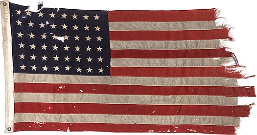 This photo shows a U.S. flag flown on the stern of the boat that led the first American troops onto Utah Beach on D-Day.