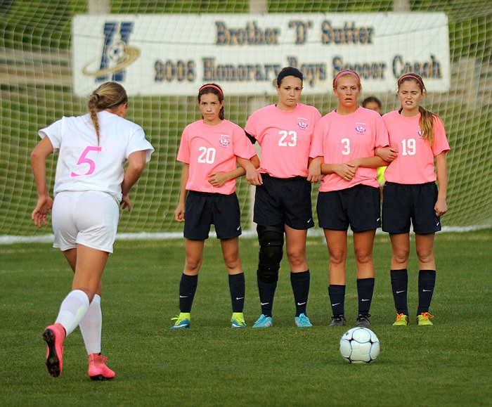 Tayler LePage of Jefferson City prepares to hit a free kick against a wall of Helias players, including Emma Wyrick (23). Wyrick was a second-team Class 3 all-state selection, while LePage was honorable mention in Class 4.