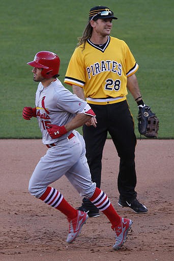 St. Louis Cardinals' Randal Grichuk, left, rounds first past Pittsburgh Pirates first baseman John Jaso (28) after hitting a solo home run off Pirates starting pitcher Jonathon Niese in the sixth inning of a baseball game in Pittsburgh, Sunday, June 12, 2016.