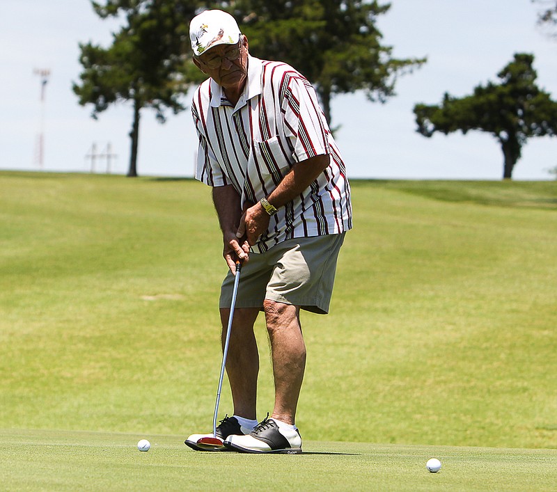 Richard Ott of California watches his putt roll on the green at the Chamber of Commerce Golf Tournament.