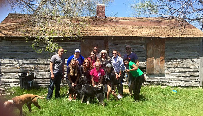 Students in front of Black Elk's cabin at the Pine Ridge Reservation in South Dakota