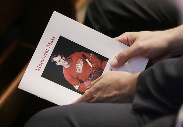 An attendee holds a program for the funeral service of Gordie Howe Wednesday at the Cathedral of the Most Blessed Sacrament in Detroit.