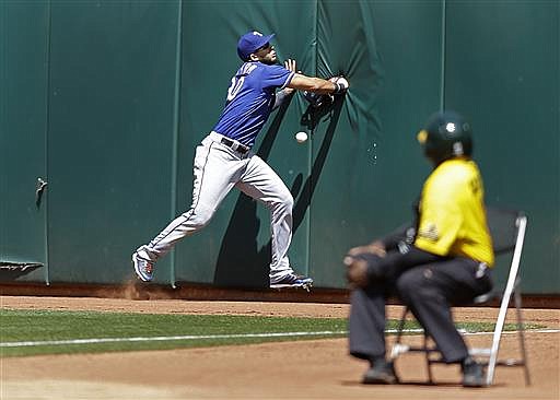 Texas Rangers right fielder Nomar Mazara cannot make the catch on a ball hit by Oakland Athletics' Max Muncy in the ninth inning of a baseball game Thursday, June 16, 2016, in Oakland, Calif. The play broke up a no hitter for Rangers pitcher Colby Lewis. 