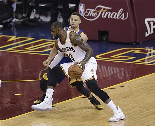 Cleveland Cavaliers forward LeBron James (23) drives on Golden State Warriors guard Stephen Curry (30) during the first half of Game 6 of basketball's NBA Finals in Cleveland, Thursday, June 16, 2016.