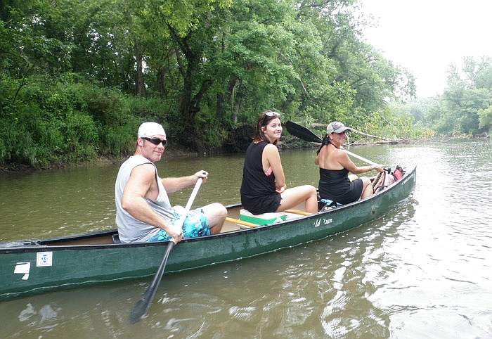 Tim Dailey, Mallory Fuller and Rhea Fuller enjoy floating an Ozark river on a beautiful summer day. 