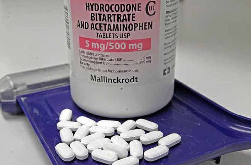 In this Feb. 19, 2013 file photo, hydrocodone bitartrate and acetaminophen pills, also known as Vicodin, are arranged for a photo at a pharmacy. 