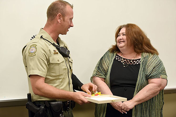 Cole County Sheriff's Deputy Travis Owens, left, receives a medal created by Donna Speckhals. 