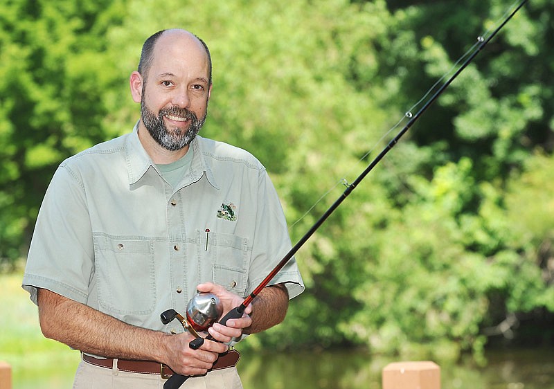 Andrew Branson poses for a photograph at the pond on Missouri Department of Conservation grounds in Jefferson City.