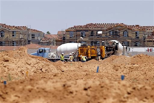 In this Wednesday, May 25, 2016, photo, crews prepare a site for new homes in Chandler, Ariz.