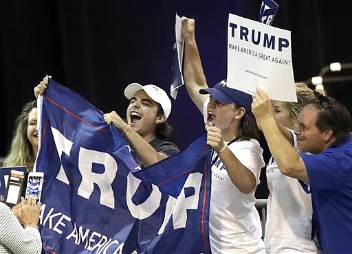 Supporters of Republican presidential candidate Donald Trump cheer after arriving for a rally Friday, June 17, 2016, in The Woodlands, Texas. 