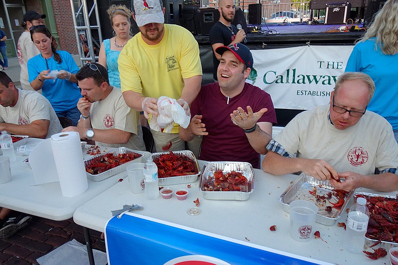 Adam Brake gets his fourth tray of mud bugs.