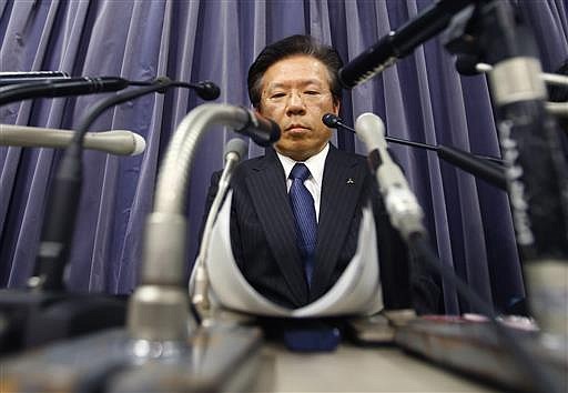 In this April 26, 2016, file photo, Mitsubishi Motors Corp. President Tetsuro Aikawa listens to a reporter's question during a press conference in Tokyo. The Japanese automaker said Friday, June 17, 2016, it will take a 50 billion yen ($913 million) charge to cover mileage-rigging expenses, including for the eK minicar models sold in Japan since 2013, and also under the Nissan label, as well as 30,000 yen ($290) compensation each for some other Mitsubishi models.