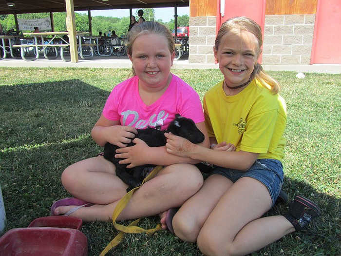 Gwen (left) and Ryan enjoy the petting zoo at Memorial Park.