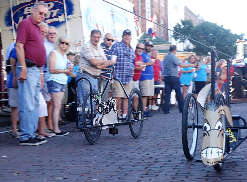 People cheer on The Callaway Cup Mule Derby participants Friday night, June 17, 2016 at the Fulton Street Fair.