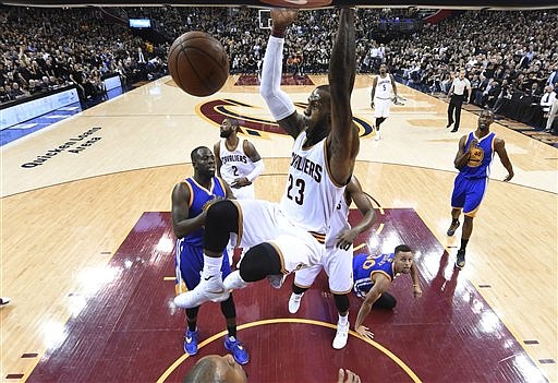 Cleveland Cavaliers forward LeBron James (23) dunks against the Golden State Warriors during Game 6 of basketball's NBA Finals in Cleveland, Friday, June 17, 2016. Cleveland won 115-101.