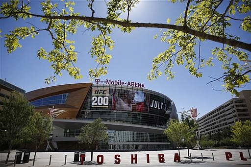 In this June 17, 2016 photo, an advertisement plays on a screen at the T-Mobile Arena in Las Vegas. A National Hockey League plan to expand to Las Vegas is being cheered by fans and backers of a years-long effort to get a pro sports franchise in Sin City, but hockey will have to elbow into a crowded entertainment lineup featuring casino games, celebrity shows, Cirque du Soleil productions and pulsing nightclubs  not to mention boxing matches, UFC fights and events like the National Finals Rodeo. 