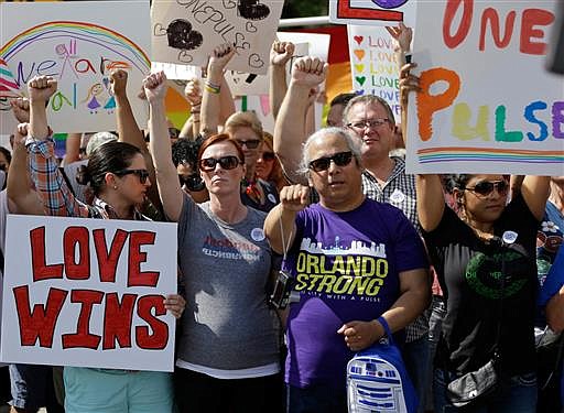 Supporters rally to show solidarity near the funeral service for Christopher Andrew Leinonen, one of the victims of the Pulse nightclub mass shooting, outside the Cathedral Church of St. Luke, Saturday, June 18, 2016, in Orlando, Fla.