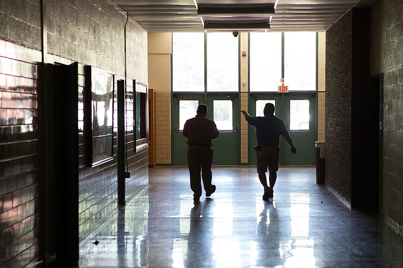 Ashdown, Ark., Superintendent Jason Sanders and Dean Lillard, maintenance facilities director, walk through the old Ashdown High School while discussing improvements planed for the upcoming renovation. 