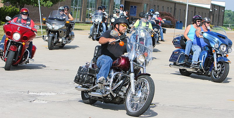 Dozens of riders leave from California High School on Saturday for the poker run to support veterans.