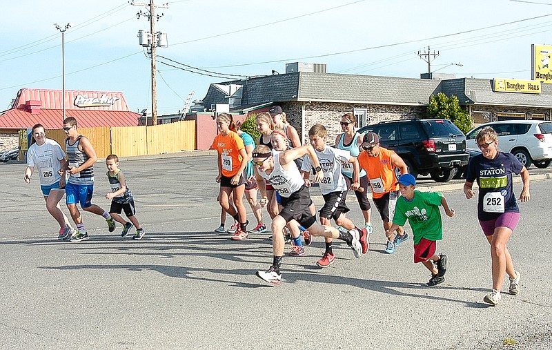 The runners come off the mark at the MCMC 5k Walk / Run which began at Village Green Shopping Center Saturday, June 18.