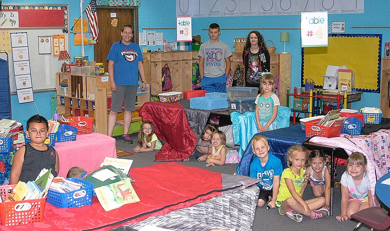 The students in Sarah Hays Summer School Class set up "tents" during the learning of the letter "T" Thursday, June 9. Standing in the back, from left are Hays, and her student assistants, Micaiah Garcia and Gwen Yarnell.